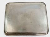 rectangular silver plate with handle on a white surface