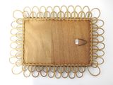 a wicker tray with a button on it
