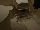 a small white table with a towel on it in a bathroom