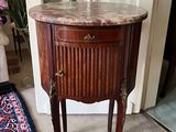 a small table with a marble top in a living room