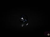 a close up of a diamond in the dark with a black background