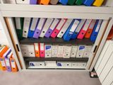 many folders on the shelves in the office