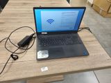 un ordinateur portable posé sur une table avec un chargeur