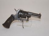 an old revolver with a wooden handle on a white surface