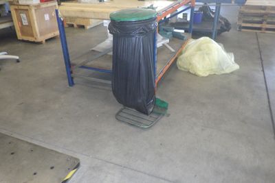une poubelle posée sur un établi dans un garage