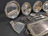 several silver plated items are displayed on a black surface
