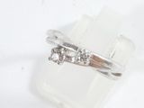 a ring with three diamonds on it sitting on a piece of rock
