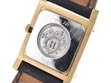 an image of a wrist watch with a coin on it