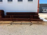 a bench sitting in front of a building next to a pile of barbed wire