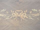 an image of a wooden table with a flower design on it