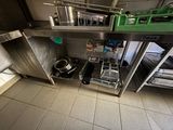 a view of a kitchen with a lot of pots and pans on the counter