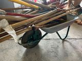 a wheelbarrow full of baseball bats in a garage