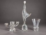 three glass vases and a glass candle holder on a table