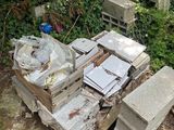 a pile of junk on the ground next to a chair