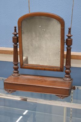 a small mirror on a glass table in a room