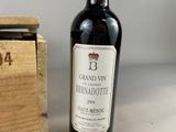 a bottle of wine sitting next to a wooden box