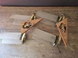 four pieces of wood and metal on a wooden table