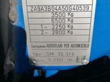 a close up of a blue motorcycle with a number plate on it