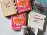 several books are stacked on top of each other on a table