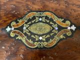 a wooden table with a black and gold design on it