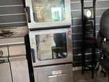 two ovens and a chair in a kitchen