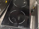 a black stove top sitting on a counter in a kitchen