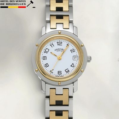 an image of a close up of a wrist watch on a white surface
