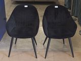 two chairs that are sitting in a room together