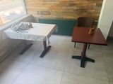a table with a white table cloth on it and a brown table with a white table cloth on it