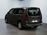 the small van is parked in the large room of the building