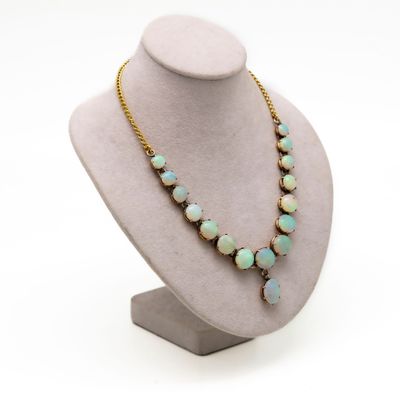 a close up of a necklace on a mannequin with a white background