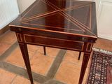 a small table with a wooden top on a tile floor