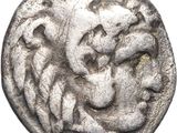 an old silver coin with a lion head on it