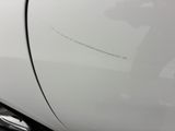 a close up of a car ' s door handle with a sticker on it