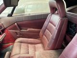 a brown leather car seat in the back of a car