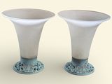 two vases that are sitting on a table