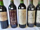 several bottles of wine are lined up on a table