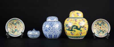 five different types of vases and bowls on a black surface
