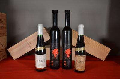 three bottles of wine sit on a table next to a wooden box
