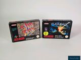 Deux boîtes de jeux sont posées sur une surface blanche.