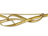 an image of a gold brooch with a knot on it