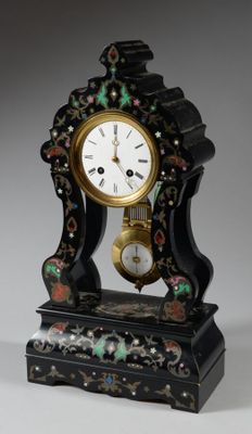 a small clock that is sitting on a table