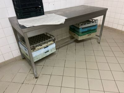 a metal table with baskets on top of it in a room