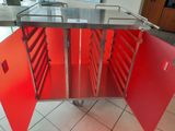 a red cabinet that has a bunch of trays in it