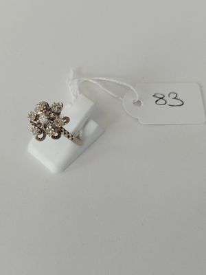 a ring with a flower on it sitting on a white surface