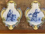 une paire de plaques en faïence de Delft bleues et blanches représentant un homme et une femme