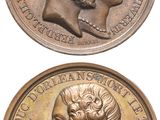 two bronze medallions depicting two heads of a man and a woman