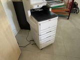 a printer sitting on top of a desk in a room