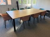 a table and chairs in a room with a large window