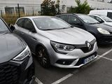 several cars are parked in a parking lot in front of a building
